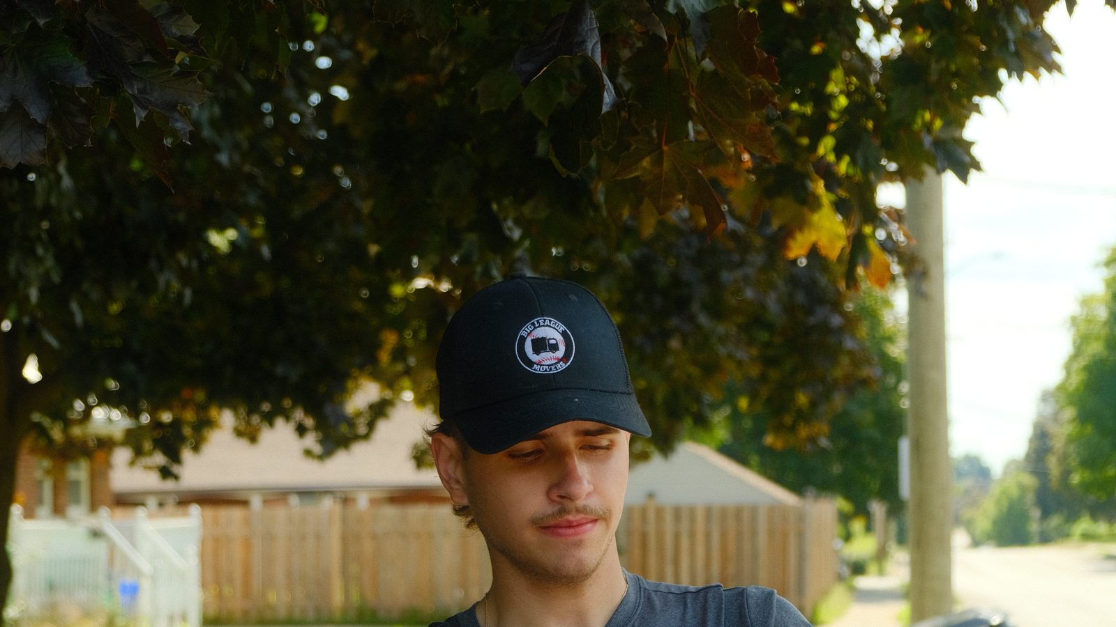 Big League Movers crew member carrying a moving bin in Barrie