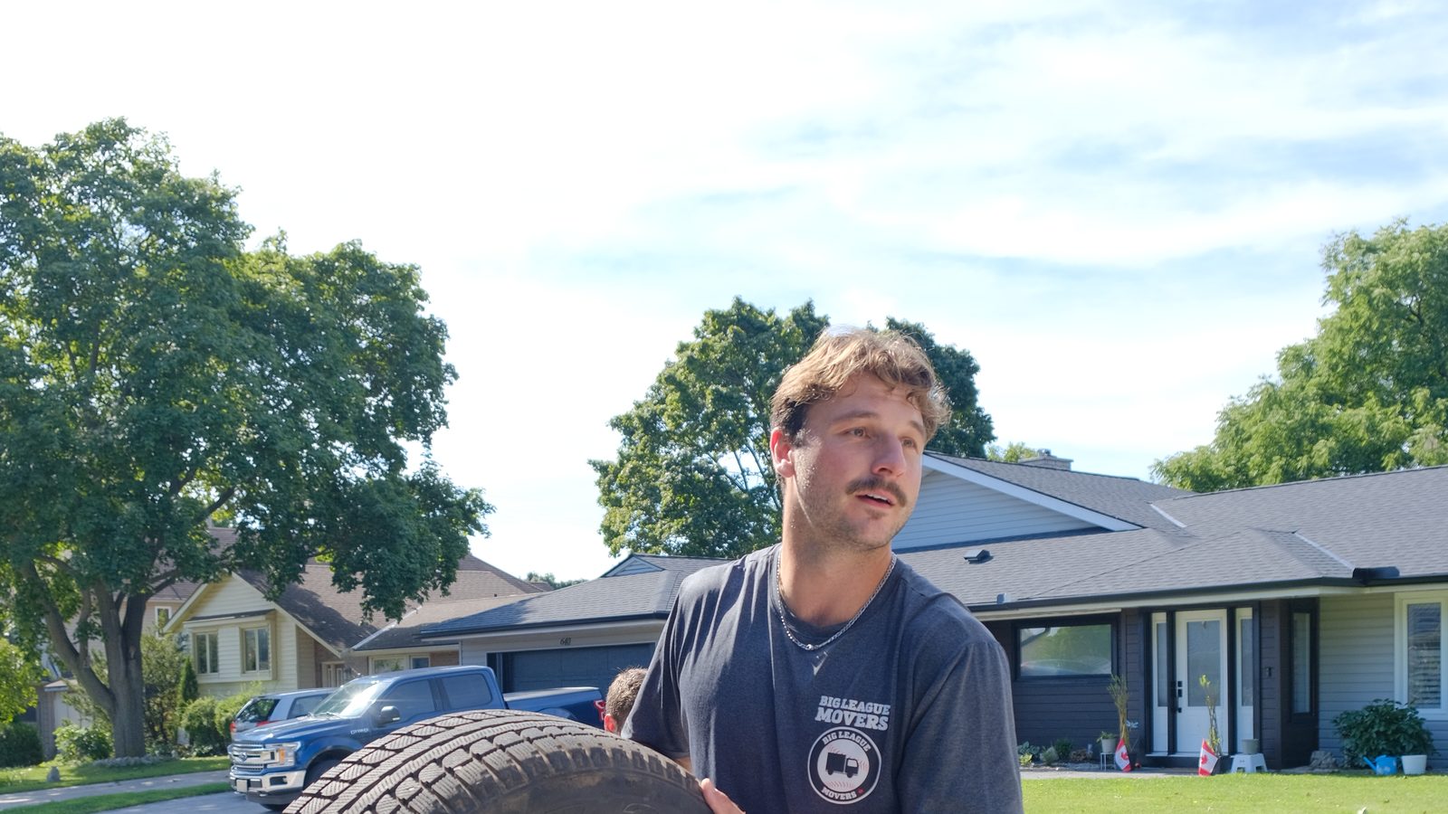 Big League Movers crew member loading equipment onto the truck ramp