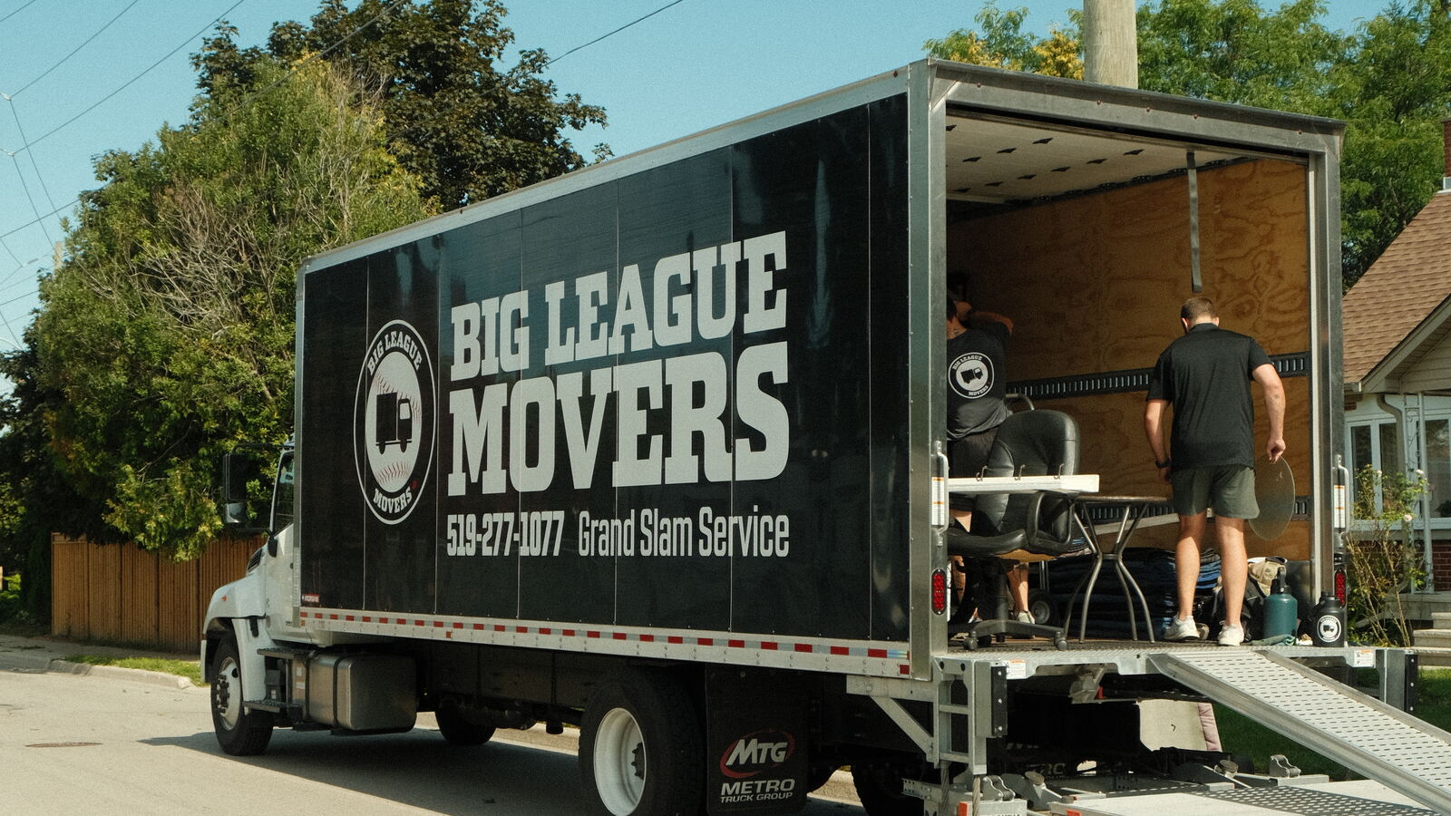 Big League Movers truck with loading ramp set up