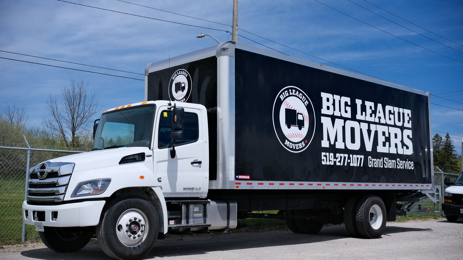 Big League Movers branded truck parked outside