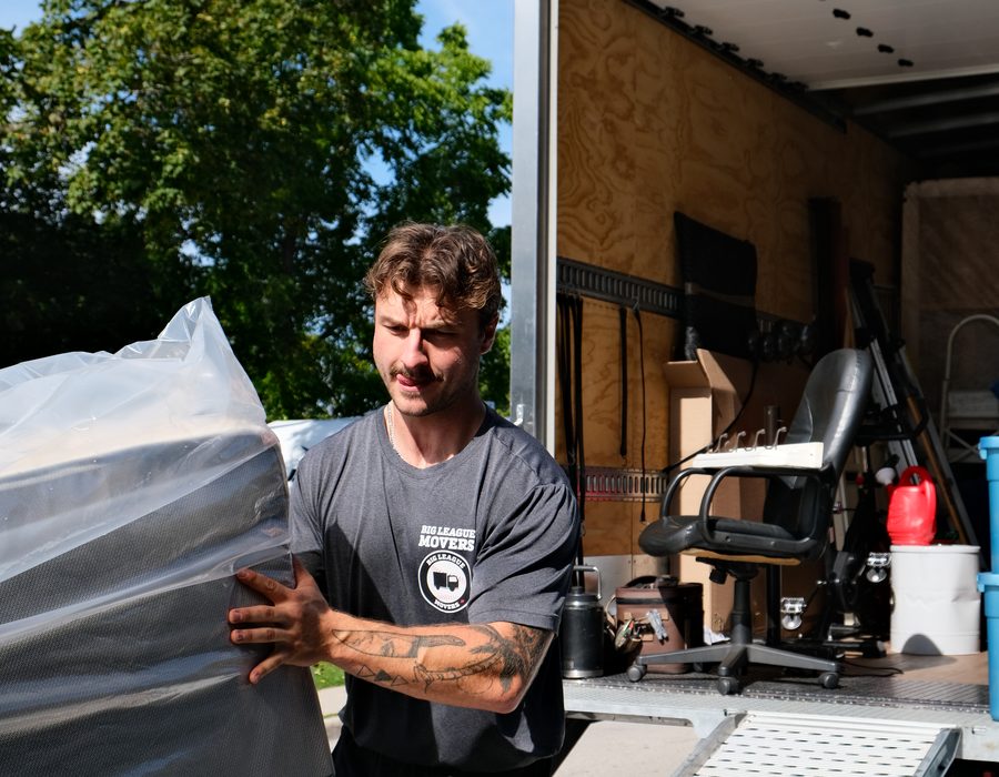 Big League Movers crew member loading a moving truck